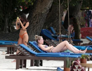 Sexy brunette friends on the beach in bikinis with great bodies
