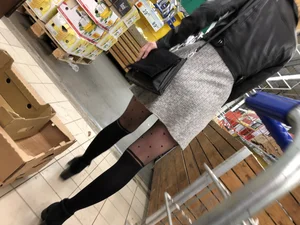 Hot milf wearing a skirt and black pantyhose with dots at the grocery store creepshot