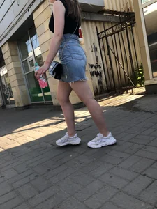 Hot chick wearing a fringed skirt walking up the stairs