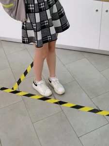 Slim Legs of a Cute Teen in a Skirt