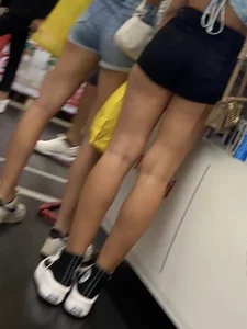 Two teens in shorts, closeups of legs