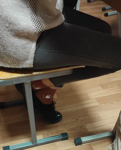 Legs in Tight Jeans and Feet in Shoes And Cute Socks, Under Desk Closeups of a College Teen in Class