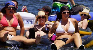 Sexy party girls in bikinis on a lake