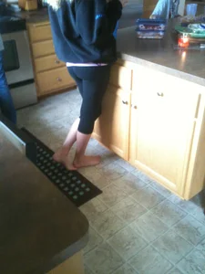 Barefoot Girl in Short Leggings Standing in the Kitchen Home Creepshot