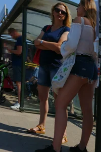 Sexy blonde showing her ass cheeks in short denim shorts and slightly see through shirt