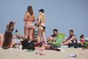 Two thick white girls in bikinis on the beach with big asses