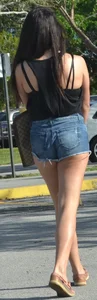 Brunette in short denim shorts showing a little cheek