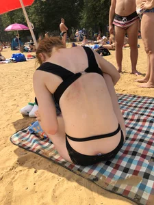 Skinny Girl in a Black Swimsuit at a Beach