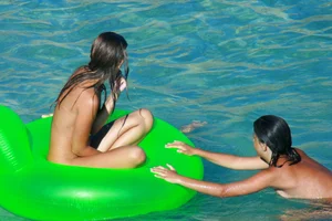 FKK Nudists playing in the water with floater