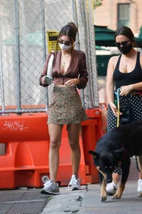Emily Ratajkowski in mini skirt out for a walk with a friend in New York
