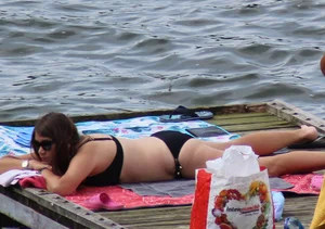Thick babe with big boobs in a black bikini