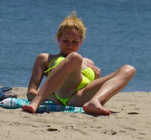 Sexy ass blonde milf on the beach in a thong with cameltoe and bending over
