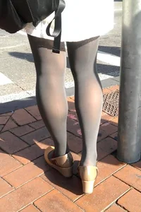 Legs in Black Pantyhose on City Street Candid Photo