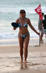 Older lady playing on the beach in her bikini