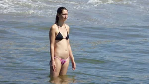 Brunette on the beach in a bikini with nice ass and small boobs