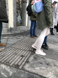 Skinny legs of a teen candid girl in white pantyhose