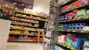 Girl shopping in short denim shorts showing some cheek