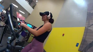 Smoking hot brunette working out at the gym in tight leggings