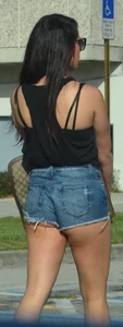 Brunette in short denim shorts showing a little cheek