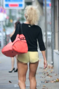 Blonde looking sexy walking in short yellow shorts