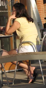 Lady in flop flops while eating showing her feet