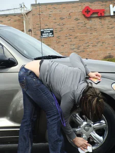 Girl cleaning her car in jeans and showing some cheetah print underwear