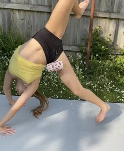 Young Athletic Barefoot Girl in Spandex Mini Shorts and a Top Laughing Her Ass Off While Doing Gymnastics