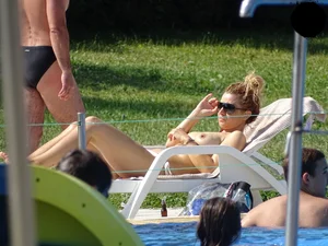 Topless lady at the pool with nice tits