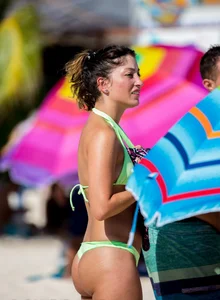A few sexy girls with great asses in thong bikinis at the beach