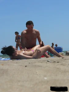 Purple thong topless lady on the beach gets oiled up by her husband