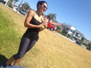 Hot brunette babe in leggings walking her dog with a nice ass and some cleavage