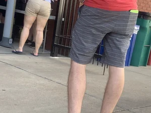 Bunch of girls in various outfits at a Cardinals baseball game