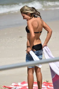 Blonde and brunette on the beach looking sexy in their bikinis