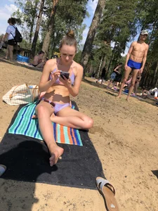 Milf Sitting in a Swimsuit Sitting on a Beach With Her Phone Creepshots
