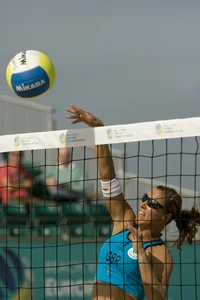 Hot girls playing beach volleyball in bikinis and shorts