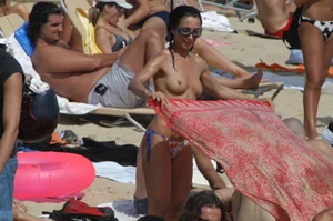 Topless girls on a beach in Barcelona