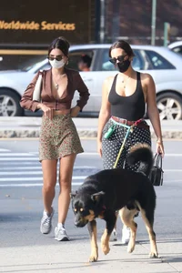 Emily Ratajkowski in mini skirt out for a walk with a friend in New York