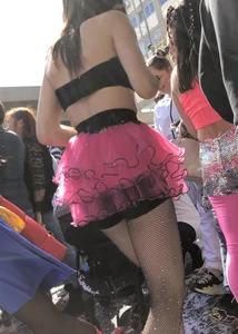 Hot carnival girl in in a top, mini shorts with pink frill and awesome legs in fishnet pantyhose