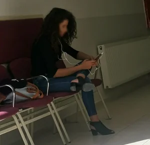 A Skinny Girl in Shoes With Heels And Tight Blue Jeans Sitting With Crossed Legs, Creepshot at the Public Library