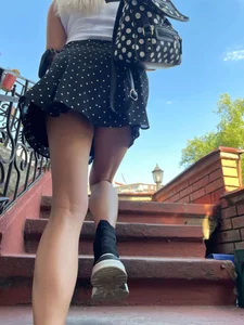 Girl in a polka-dot skirt walking up the stairs
