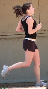 Cute girl running in short shorts