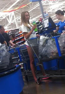 Teen blonde candid hottie in pink mini shorts at the store creepshots