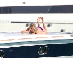 Avril Lavinge looking sexy in purple bikini on a boat