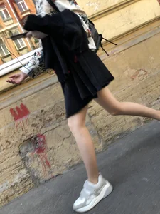 Nice slim legs of a candid girl wearing a leather skirt