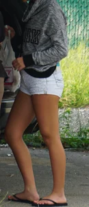 Girl next door teen neighbor bringing in groceries in short jean shorts
