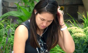 Thick brunette listening to music in shorts