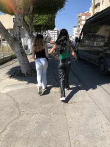 Two hot gals, one in tight jeans, another in leather pants