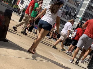 Bunch of girls in various outfits at a Cardinals baseball game