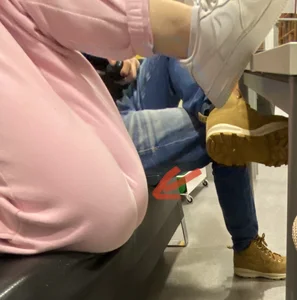Skinny Ass in Loose Pink Pants And Feet in Sneakers - Girl Lying on the Couch With Her Legs Up