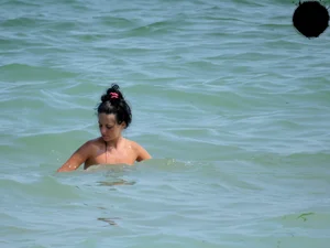 Brunette topless babe with cute tits and a nice ass in a thong bikini